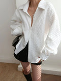 Women's blouse with textured surface and sculptured sleeves