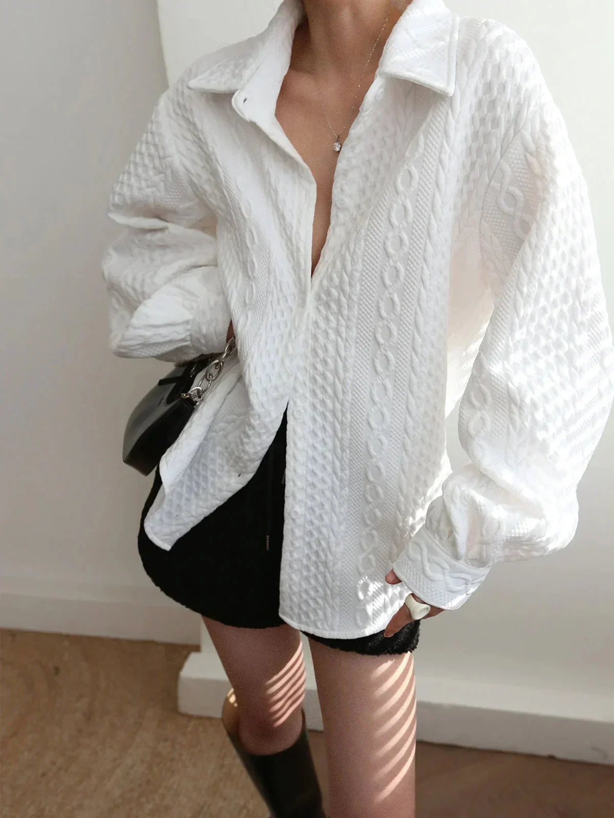 Women's blouse with textured surface and sculptured sleeves