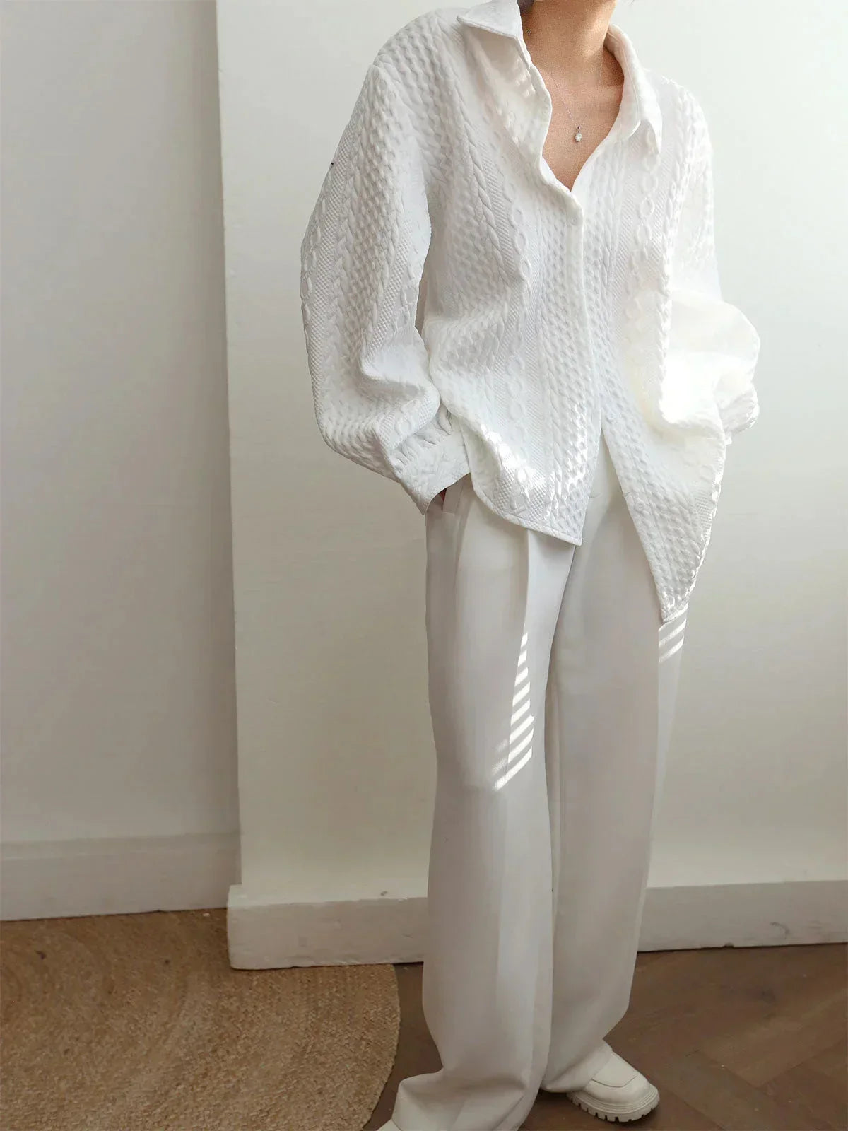 Women's blouse with textured surface and sculptured sleeves
