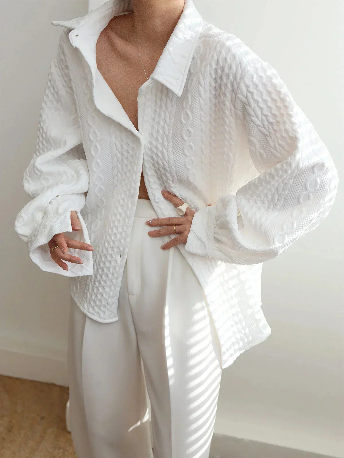 Women's blouse with textured surface and sculptured sleeves