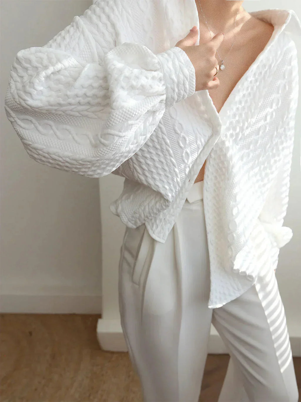 Women's blouse with textured surface and sculptured sleeves