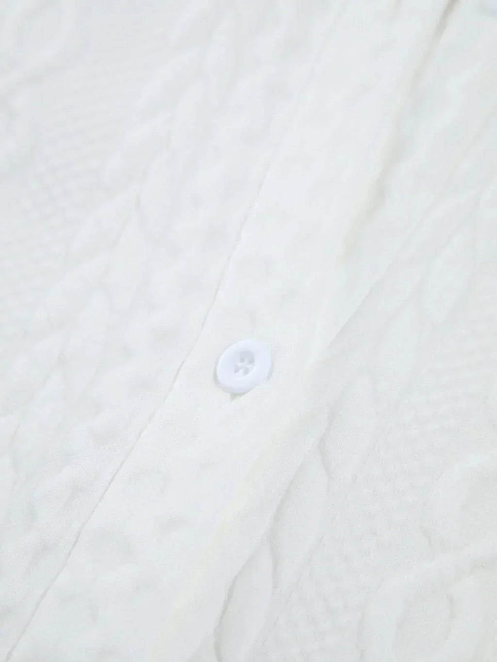 Women's blouse with textured surface and sculptured sleeves