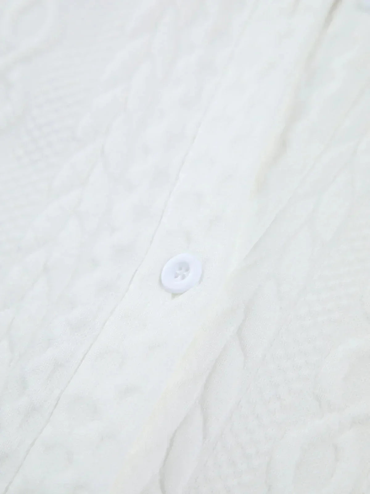 Women's blouse with textured surface and sculptured sleeves