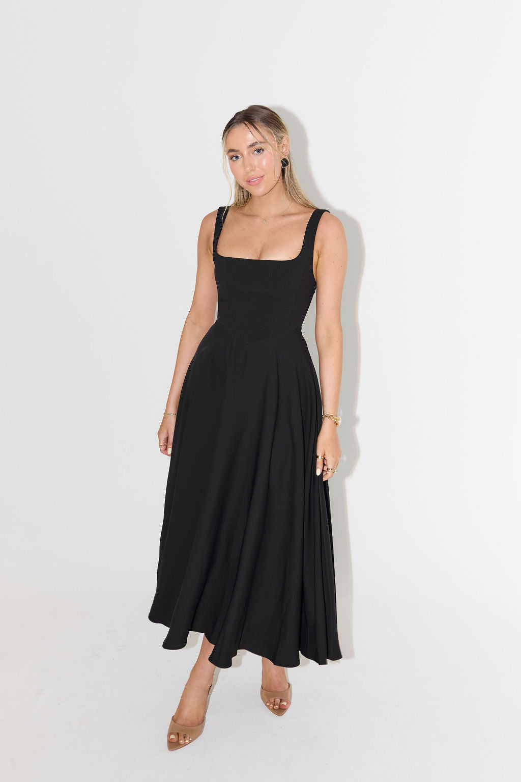 Women's midi dress with cinched waist and flowing skirt